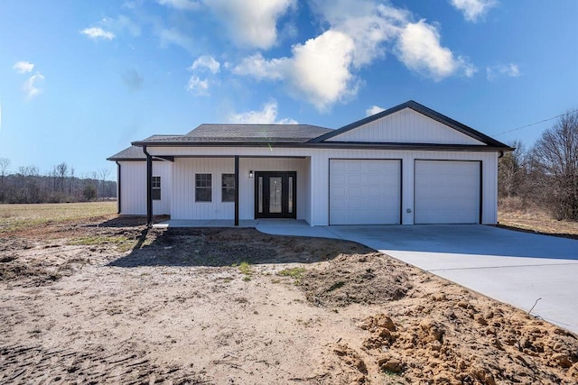 view of front of house featuring a porch and a garage