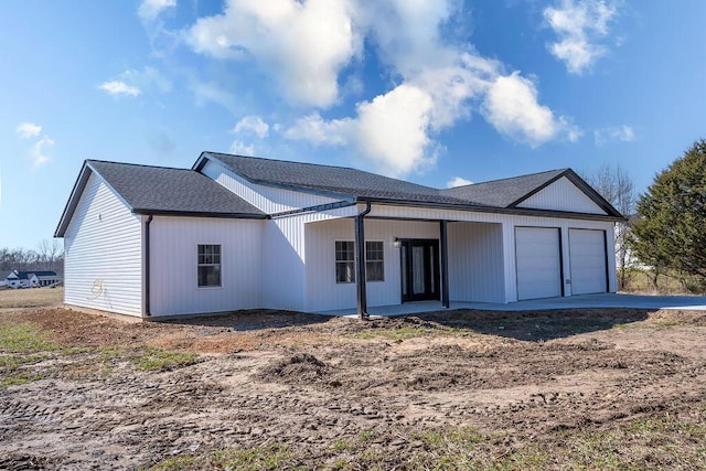 rear view of house featuring a garage