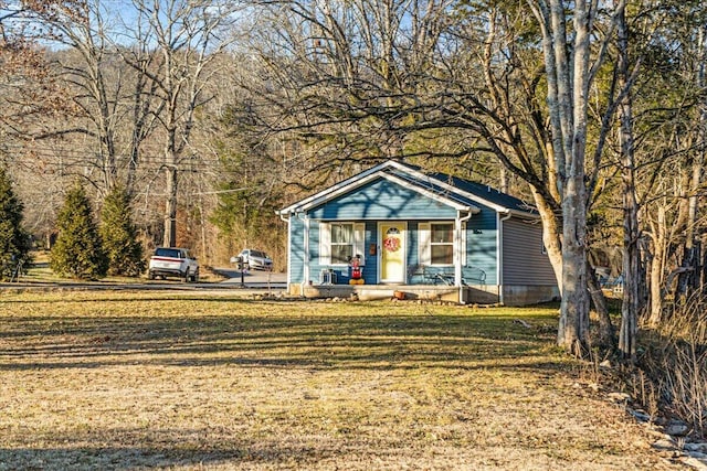 bungalow-style house with covered porch and a front lawn