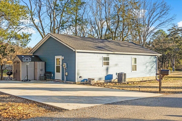 view of side of property with central air condition unit