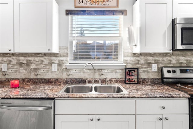 kitchen with white cabinetry, sink, and stainless steel appliances