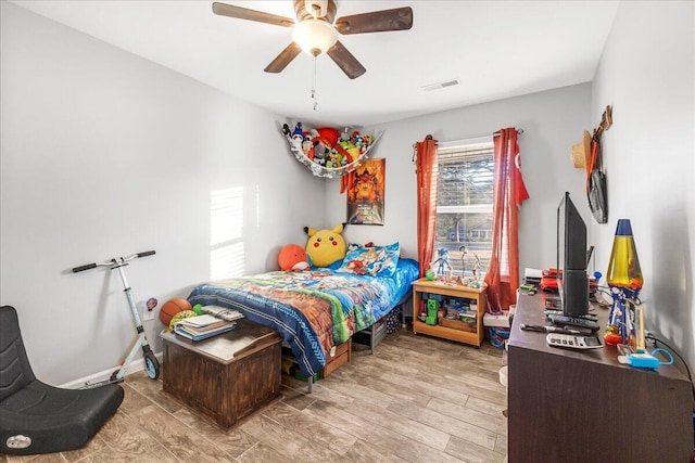 bedroom with light hardwood / wood-style flooring and ceiling fan