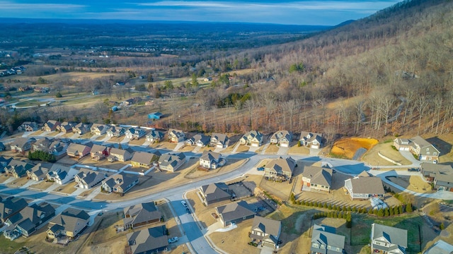 birds eye view of property featuring a wooded view and a residential view