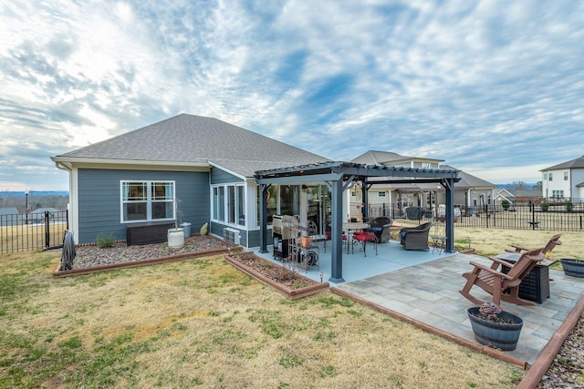 rear view of property with a lawn, a patio area, a fenced backyard, and a pergola