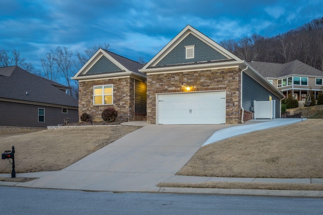 craftsman house featuring concrete driveway and an attached garage