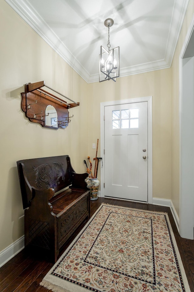 entryway with dark wood-style flooring, a notable chandelier, crown molding, and baseboards