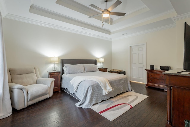 bedroom with a raised ceiling, visible vents, dark wood-type flooring, ornamental molding, and ceiling fan