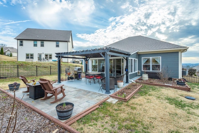 back of house featuring a yard, a patio, an outdoor fire pit, a pergola, and a fenced backyard