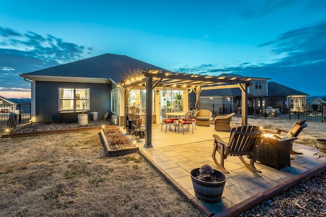 rear view of house featuring a patio area, a shingled roof, fence, and a pergola