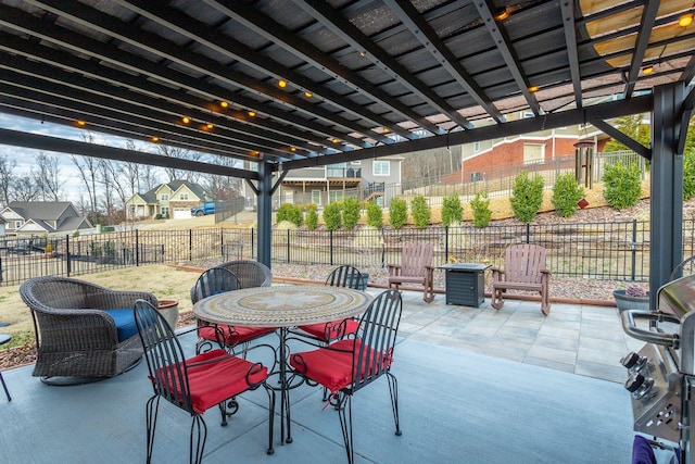 view of patio / terrace with a fenced backyard, a residential view, and outdoor dining space