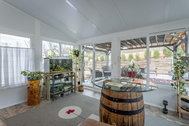 sunroom featuring vaulted ceiling