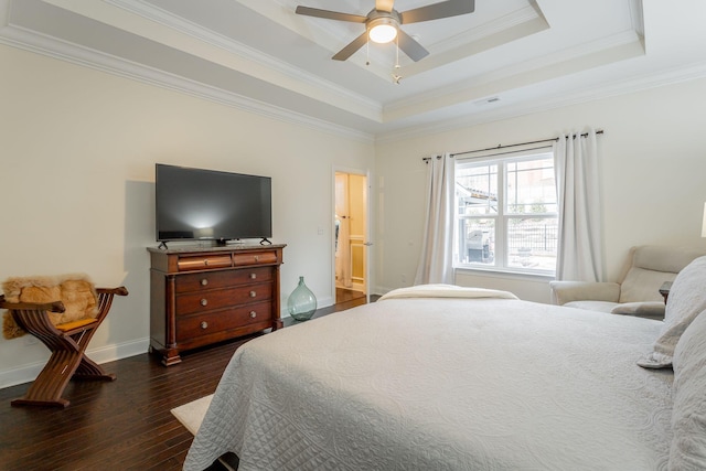 bedroom featuring baseboards, a ceiling fan, dark wood-style flooring, a tray ceiling, and crown molding