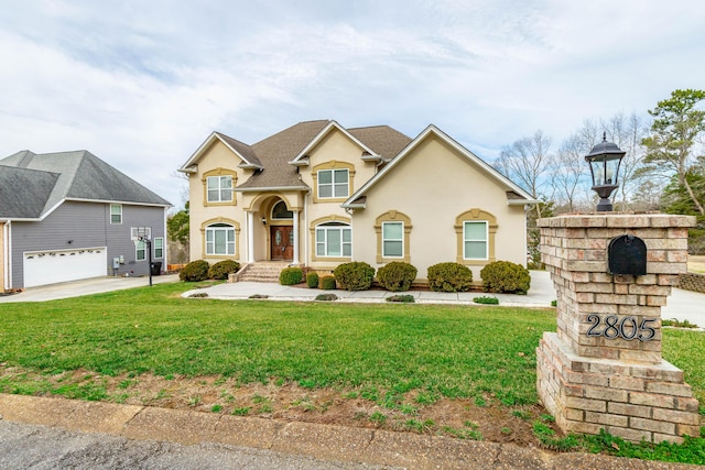 view of front of house with a garage and a front yard