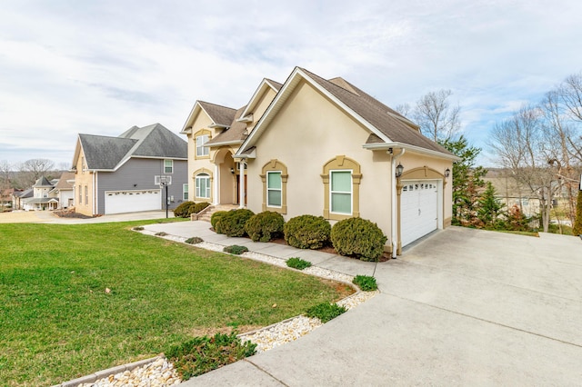 view of front of home with a garage and a front lawn