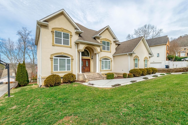 view of front of property with a garage and a front lawn