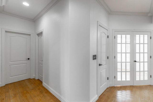 interior space with crown molding, french doors, and light wood-type flooring