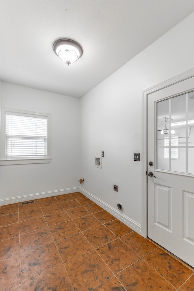 laundry room with dark tile patterned floors, electric dryer hookup, and washer hookup