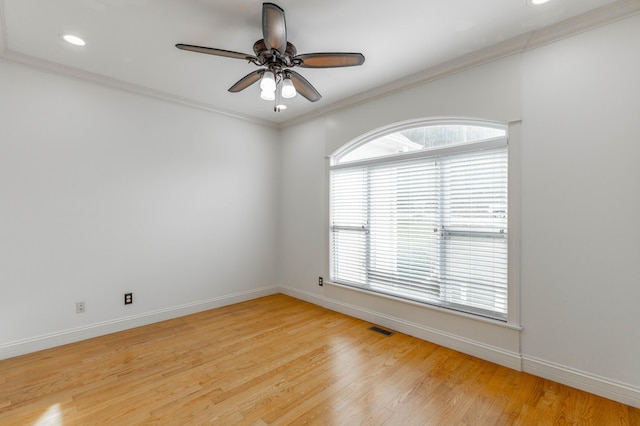 empty room with crown molding, ceiling fan, and light hardwood / wood-style flooring