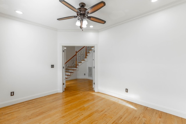 empty room featuring crown molding, light hardwood / wood-style floors, and ceiling fan