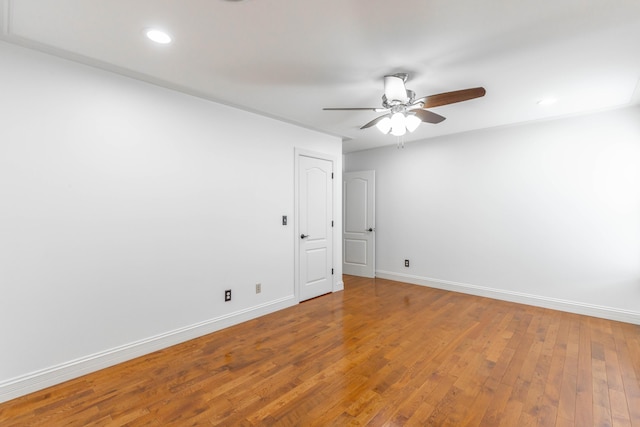 unfurnished room featuring ceiling fan and hardwood / wood-style floors