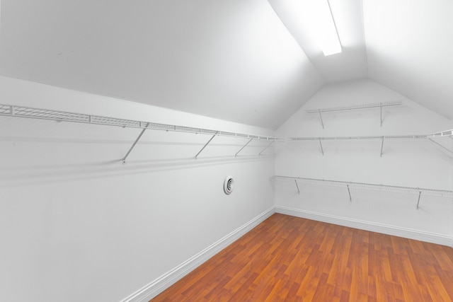 walk in closet featuring lofted ceiling and hardwood / wood-style floors