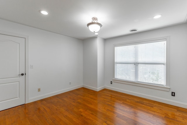 spare room with hardwood / wood-style floors