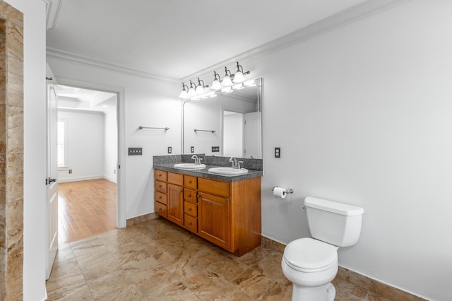 bathroom featuring crown molding, vanity, and toilet