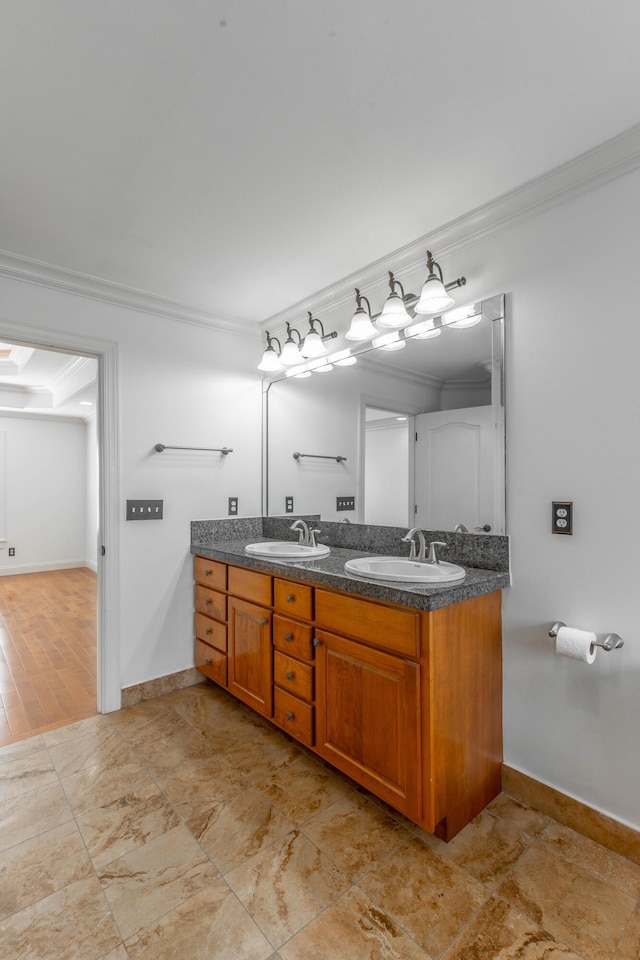 bathroom with ornamental molding and vanity