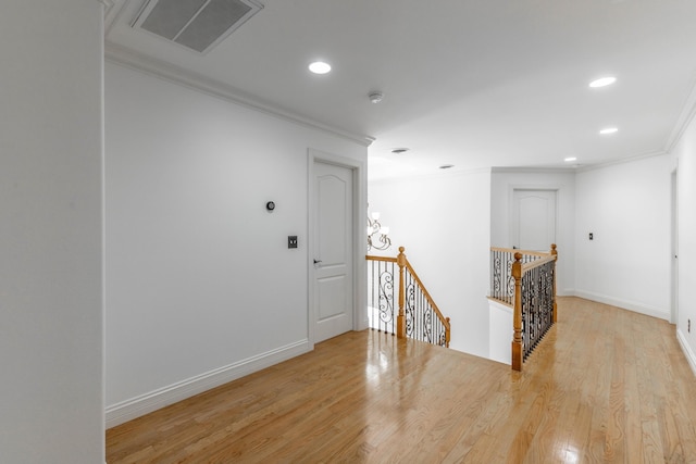 hallway with ornamental molding and wood-type flooring