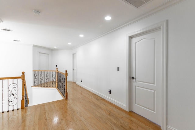 interior space featuring ornamental molding and light hardwood / wood-style flooring