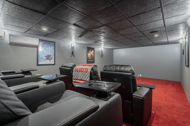 home theater featuring a paneled ceiling, a wall unit AC, and carpet