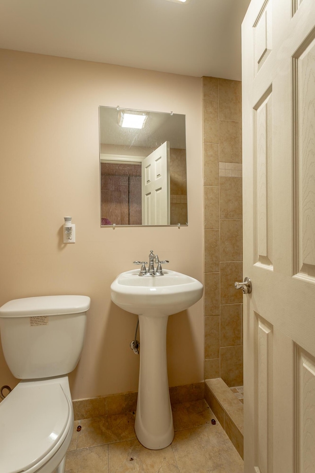 bathroom featuring tile patterned flooring and toilet