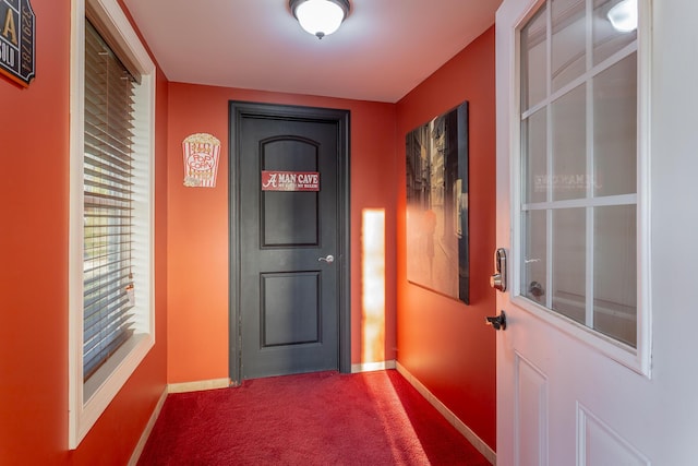 doorway to outside with carpet flooring