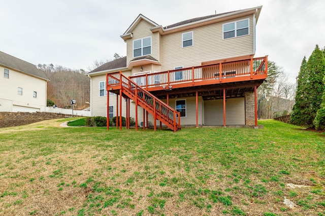 rear view of house with a yard and a deck