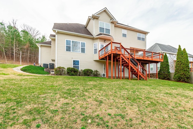 back of property with a yard and a deck