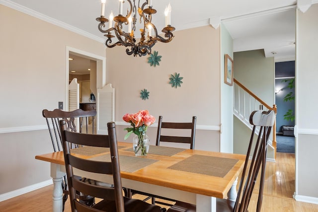 dining room with crown molding and light wood-type flooring