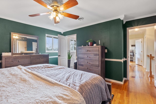 bedroom with ornamental molding, light hardwood / wood-style floors, and ceiling fan