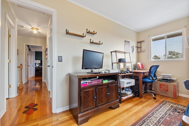 office space with crown molding and light wood-type flooring