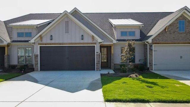 craftsman inspired home featuring a garage and a front yard