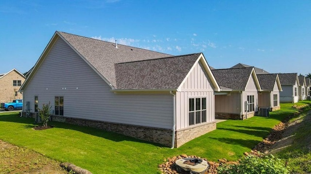 view of home's exterior featuring central AC and a yard