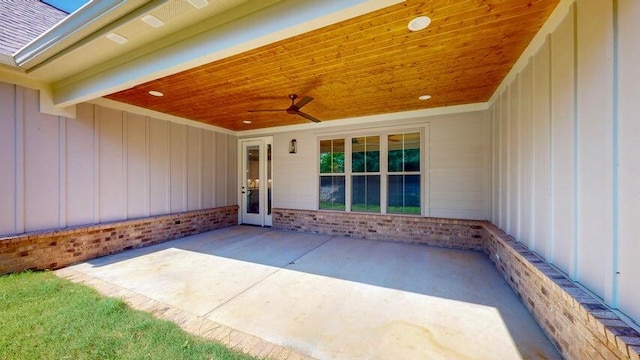 doorway to property with ceiling fan and a patio area