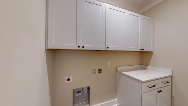 clothes washing area featuring cabinets, hookup for a washing machine, and hookup for an electric dryer