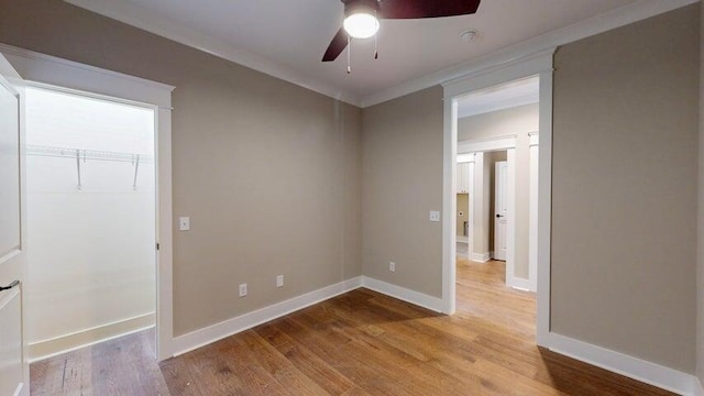 unfurnished room with ornamental molding, ceiling fan, and light hardwood / wood-style flooring