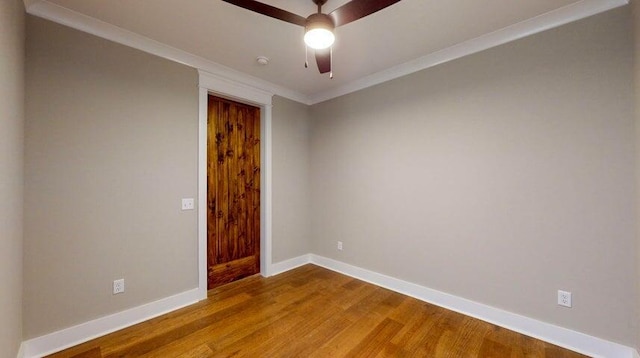 empty room with ceiling fan, ornamental molding, and wood-type flooring