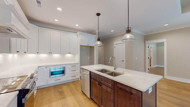kitchen with a kitchen island with sink, sink, stainless steel appliances, and white cabinets