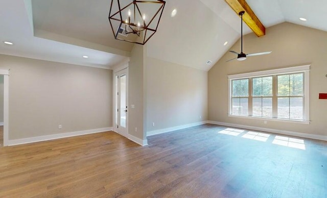 unfurnished living room with hardwood / wood-style flooring, ceiling fan with notable chandelier, and vaulted ceiling with beams