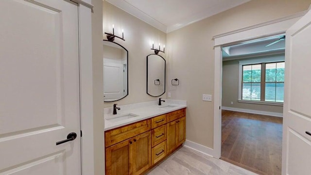 bathroom featuring vanity, hardwood / wood-style flooring, and ornamental molding