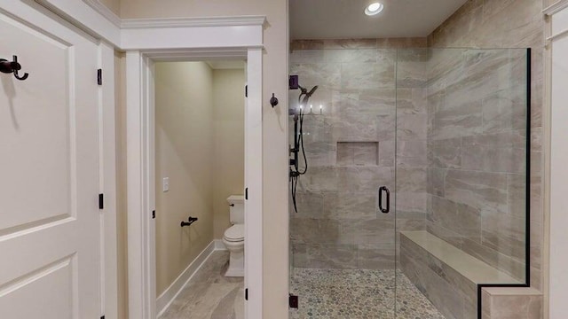 bathroom with an enclosed shower and toilet