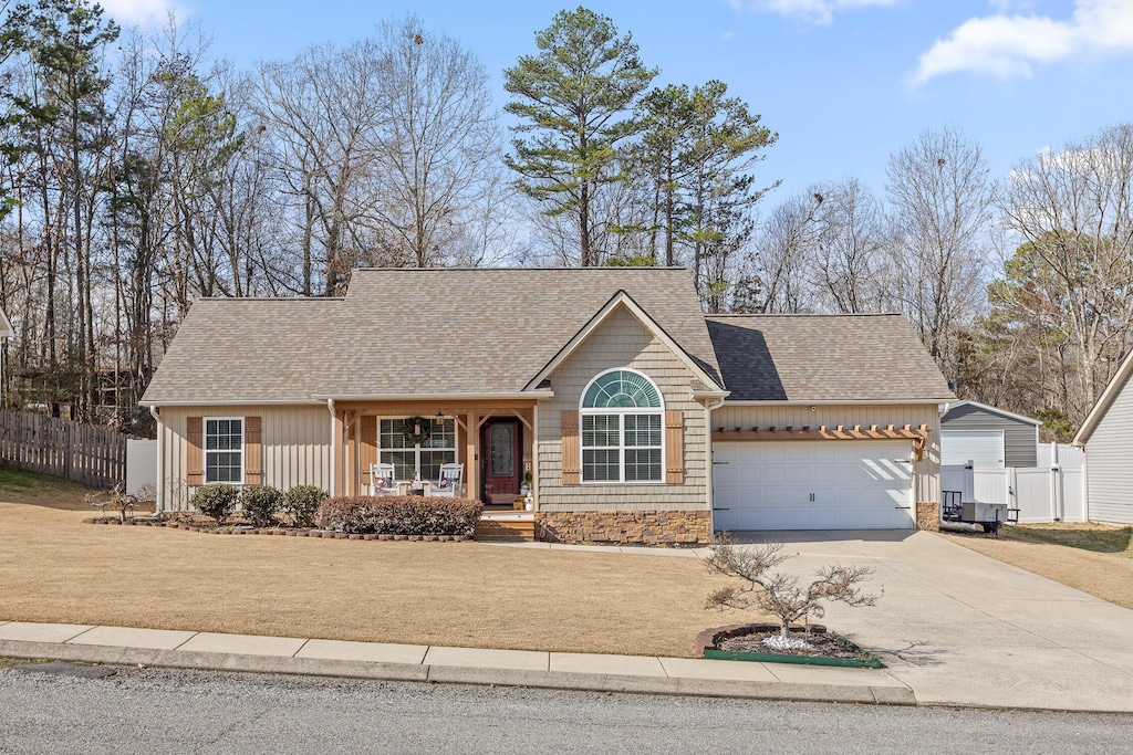 single story home with a garage and covered porch