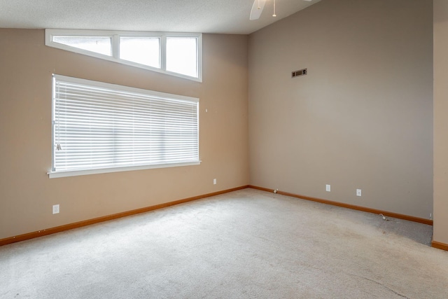 unfurnished room featuring baseboards, visible vents, a textured ceiling, and light colored carpet